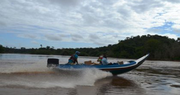 Ministry of Health officials on the way to deliver drugs to a riverine community by water transport