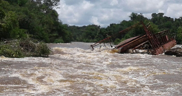 Engineers are battling to remove this dredge that sank in the Mazaruni River
