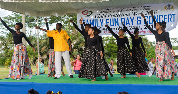 Dancers finish their performance during the Child Protection Week Fun Day at the Botanical Gardens on Saturday. (Photo by Delano Williams)