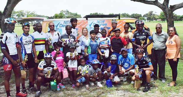 Prize-winners of the various categories of the DeSinco Trading Degree 11-race cycle programme strike a pose with race organizer Hassan Mohamed (second right) yesterday (Cullen Best-Nelson photo)