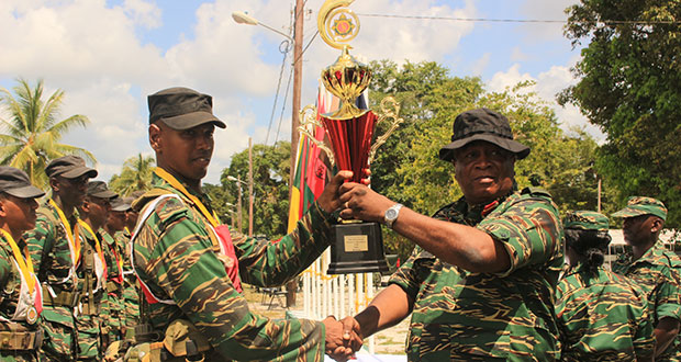 Special Forces Squadron’s “B” team’s captain (left) receiving the winning trophy from outgoing Chief-of-Staff, Brigadier Mark Phillips, after his team won the Third Quarterly Fitness competition at Base Camp Stephenson on Friday (Ravin Singh photo)