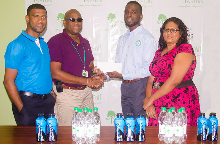 From left: Errol Nelson, Banks DIH Water Beverage Manager Clive Pellew handing sponsorship package to Assistant Director of Sport Brian Smith and Ms Sooklall of the NSC.