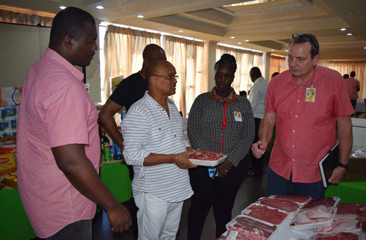 (From right) Camp Services Manager Michael Herpel and Logistics personnel Nichola Scott inspect a vendor’s display with Camp Services’ Troy Semple, at far left
