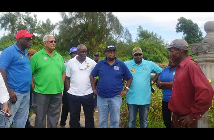 Minister Holder and members of his team  speaking to a farmer during the outreach