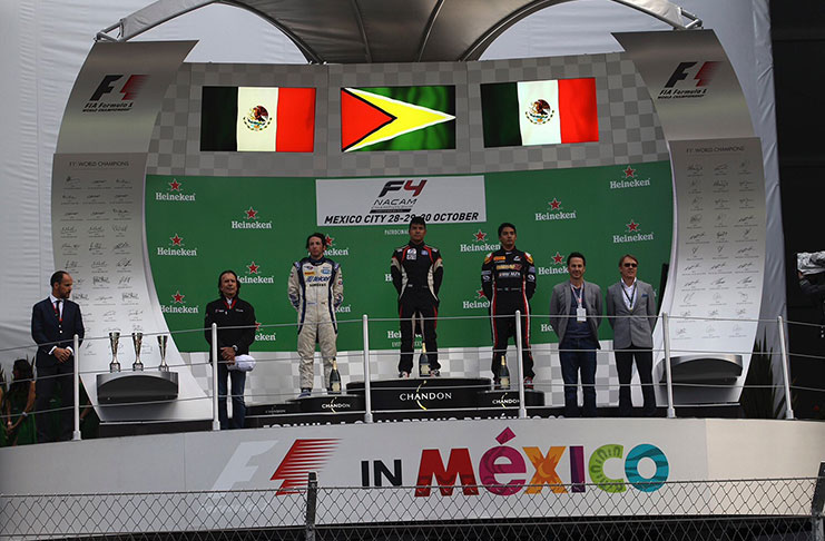 Calvin Ming (centre) is all smiles as he stands on the F4 podium after winning race-two yesterday.