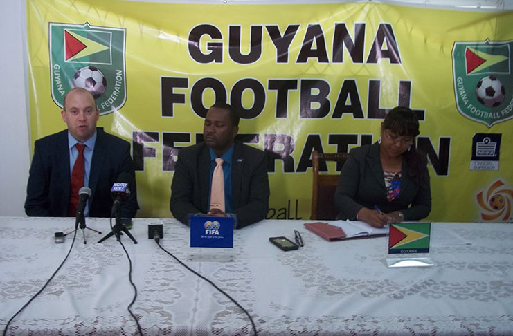 GFF's new Technical Director, Ian Greenwood, addresses the media yesterday at the Federation's boardroom. President of the GFF, Wayne Forde, and PRO Debra Francis are also in picture.