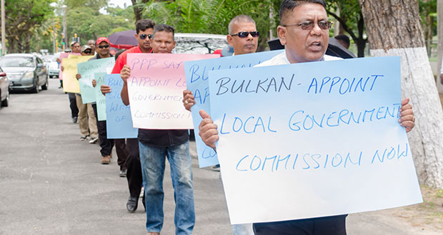 PPP Executive Member Zulfikar Mustapha leading a protest on Tuesday in front the Ministry of the Presidency