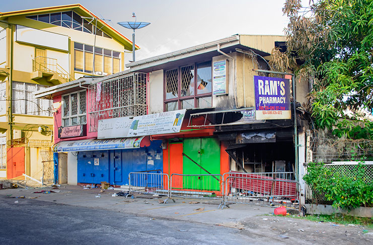 An external view of the gutted Ram’s Pharmacy and neighbouring stores