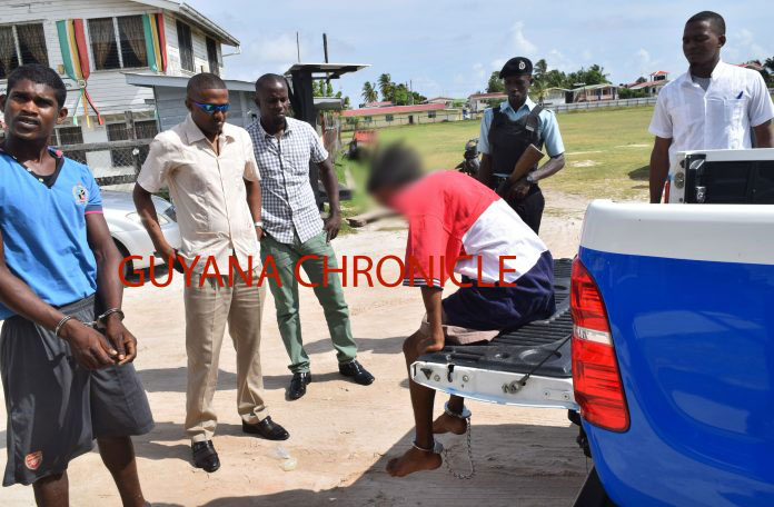 Daveanand Rampersaud (extreme left) and the teenager (sitting in vehicle) arrive at the Sparendaam Magistrate's Court.