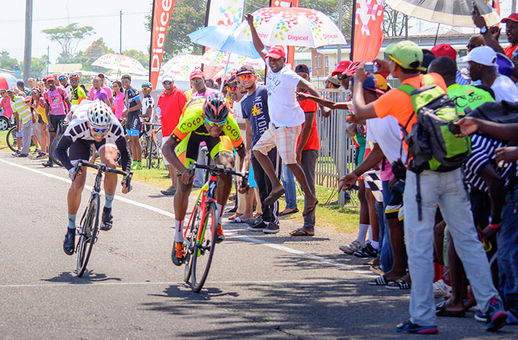 Jamal John at right staves off the challenge of Raul Leal to win the Digicel sponsored Cancer Awareness cycle road race yesterday around the outer circuit of the National Park (Samuel Maughn photo).