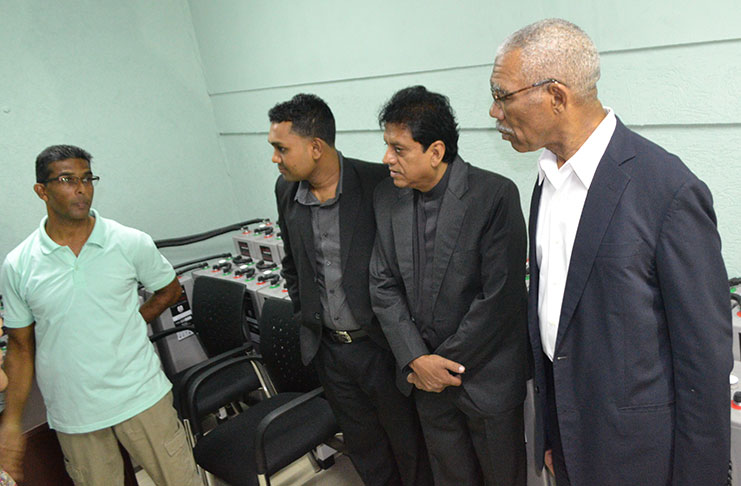 President Granger engages officials of the bank during a tour of the building .