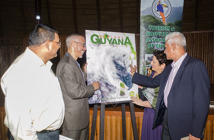 The Tourism and Hospitality Association of Guyana (THAG) on Saturday evening unveiled the 18th edition of Explore Guyana, a 108-page magazine that allows those at home and abroad to discover the beauty of
Guyana. This year, the Harpy Eagle, one of the ‘giants’ of Guyana and an endangered species worldwide, takes centre stage, with its rare but enthralling beauty captured on the cover. In this photo, publisher Lokesh Singh discusses the significance of the cover in the presence of THAG President Andrea de Caires, on his right; and Minister of Business, with responsibility for Tourism, Dominic Gaskin; and Director of the Guyana Tourism Authority (GTA), Indranauth Haralsingh, on the left (Delano Williams photo)