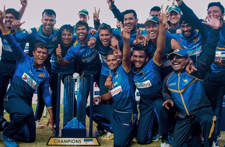 Upul Tharanga and his team pose with the winner's trophy in the  tri-series final in  Bulawayo,yesterday.