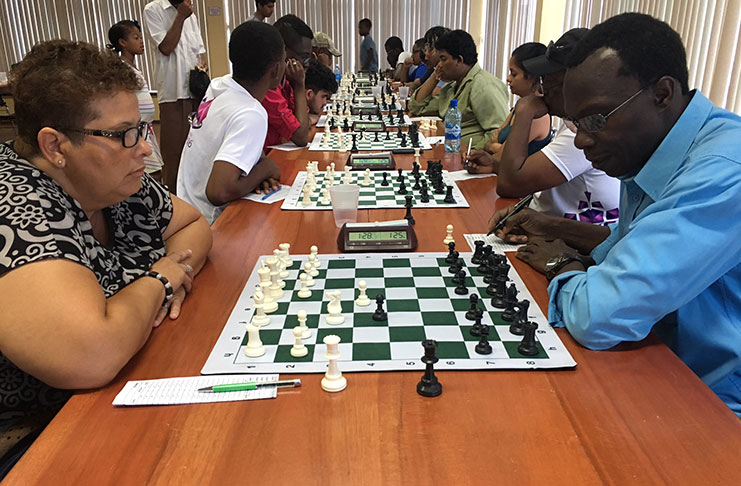 Some of the players locked in battle last Sunday.At left is Women’s FIDE Master Maria Varona-Thomas