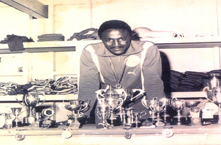 Victor Benjamin displays his silverware from a track meet in the 1970s.