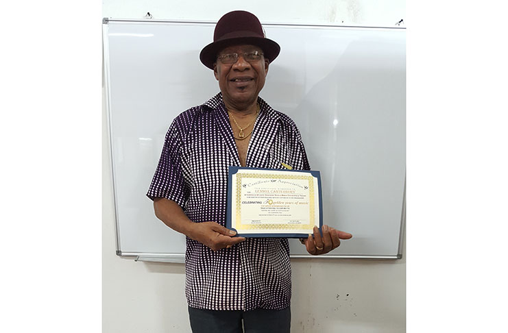 Rudy Bishop as he displays one of the certificates which will be presented to awardees on Saturday at the reception