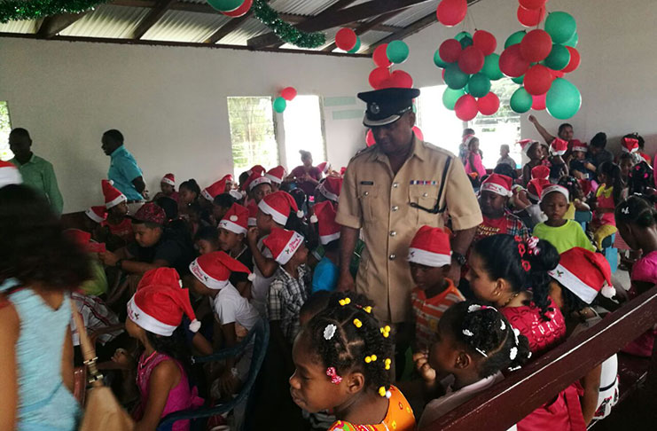 Commander Ravindradat Budhram interacts with some of the children