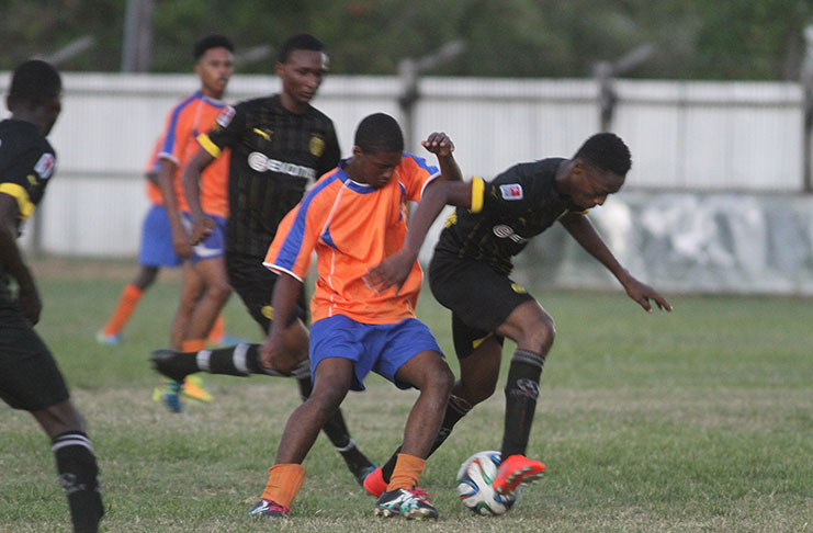 The battle for ball possession was intense in yesterday's U-19 League fixture when Uitvlugt Warriors (All Black) upset Fruta Conquerors (Orange and Blue) 2-1 at Tucville.