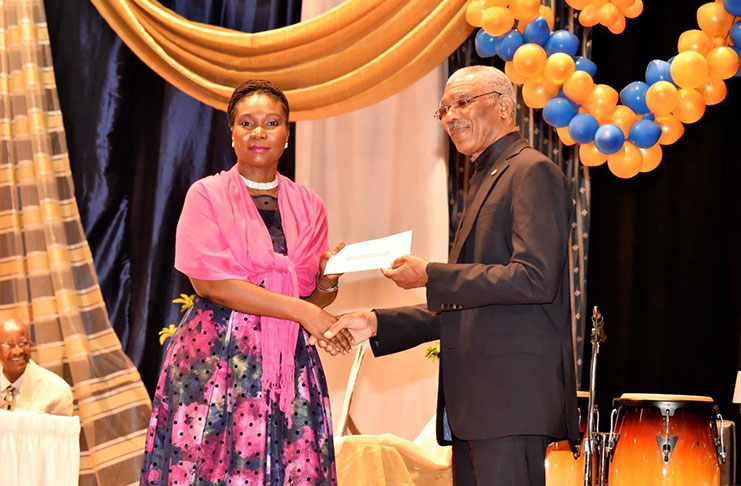 Principal of the CPCE, Ms. Viola Rowe, receiving the $1M cheque from President David Granger, for boosting of Science and technology subjects and facilities at the institution (MOTP photo)