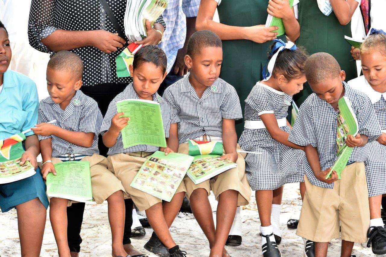 Some nursery school students received exercise books with photographs of some of Guyana's largest animals on the cover from President David Granger, during his visit to Caria Caria