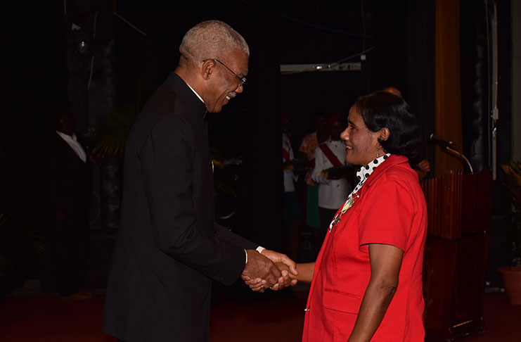 Jaitun Haniff-Persaud receiving her Medal of Service from President David Granger in 2015