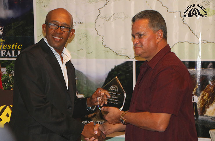 Denis Chabrol of Demerara Waves receives Roraima’s Highest Award, the Captain Alvin Clarke Award for Militancy and Innovation from Captain Gerry Gouveia.