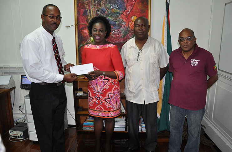 From L-R (GNRA and West Indies Full-bore secretary Ryan Sampson stands with Junior Minister of Education Nicolette Henry and GNRA executive members Lennox Braithwaite and Terrance Stuart