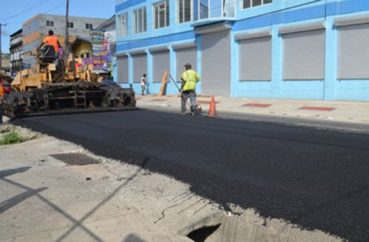 Workers from the Ministry of Public Infrastructure’s Special Projects Unit applying asphalt on Lombard Street