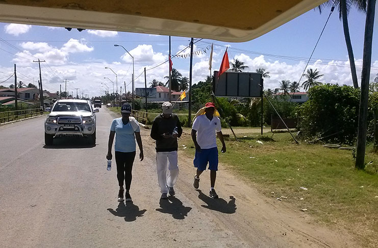 GBA president Steve Ninvalle (right) and vice president Maurice Rajkumar (centre) take to the West Berbice road.