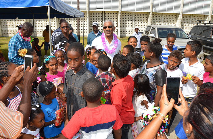 President David Granger surrounded by the children of Region Two