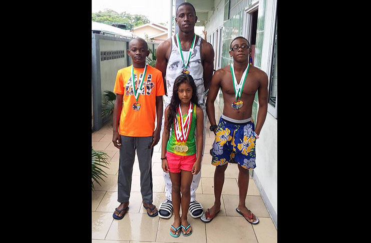 The Guyanese swimmers who medalled, from left: Leon Seaton, Ariel Rodrigues, Trumaine Cole and Shaqueel Amin (at the back)