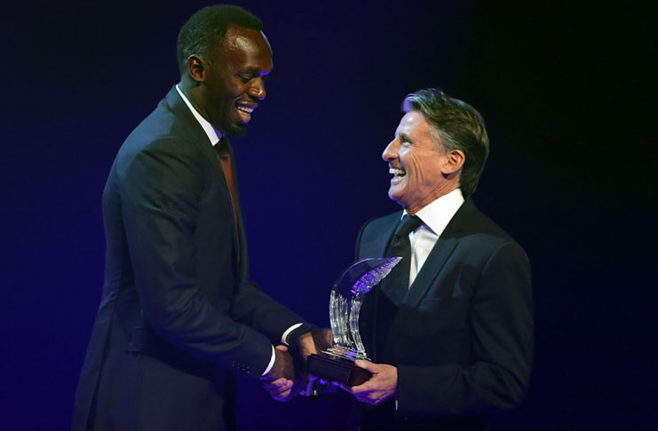 Jamaican athlete Usain Bolt (left) shakes hands with IAAF President Sebastian Coe after being awarded 2016 male world athlete of the year in Monaco last Friday during the International Association of Athletics Federations (IAAF) gala. PHOTO | VALERY HACHE | AFP