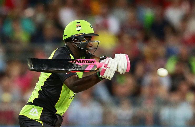 Andre Russell gears up to play a shot, with his black bat.