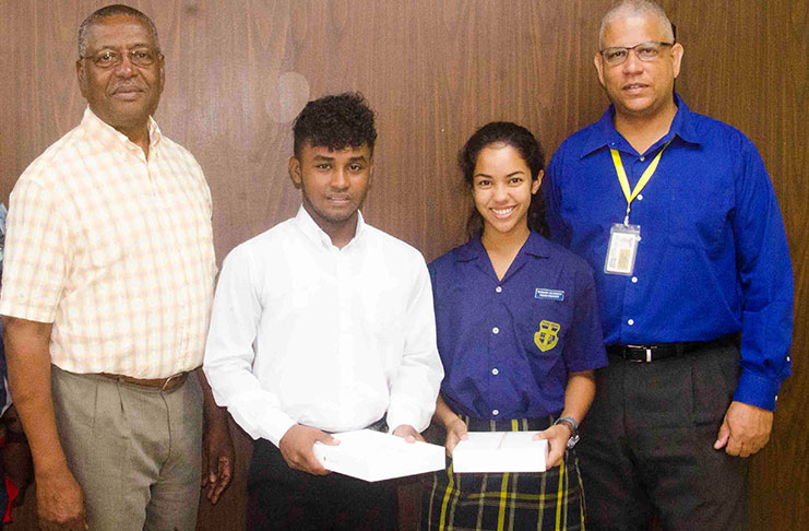 Banks DIH Limited Co-Managing Director/Marketing Director Mr George McDonald (left) and Sales Executive Mr Carlton Joao pose with Sports Brand Ambassadors Kemo Cornelius and Rebecca Low.