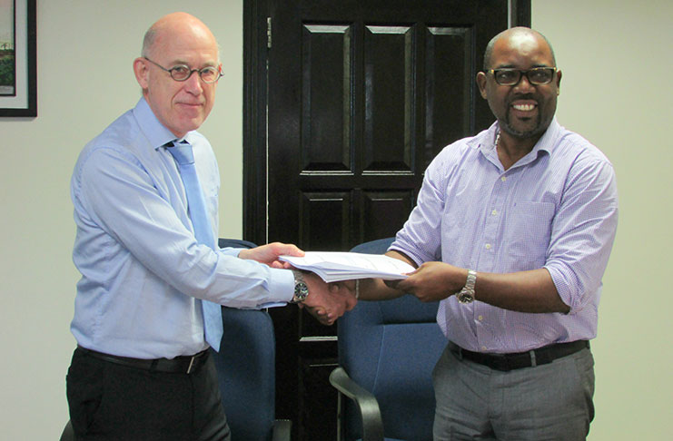 In photo, DHBC General Manager, Mr. Rawlston Adams (right), and Mr. Arie Mol of Lievense CSO (left) shake hands following the signing of the contract.
