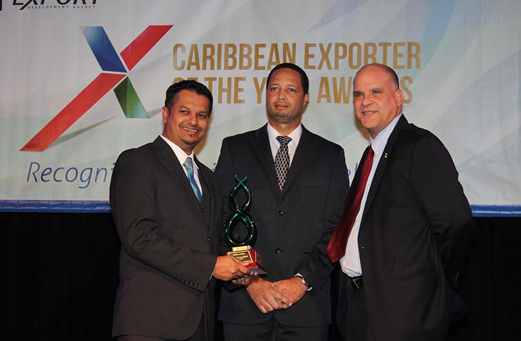 Managing Director of the Nand Persaud International Communications Inc, Darren Ramdial (left); and Chief Executive Officer of the Guyana Office for Investment (GO-Invest), Owen Verwey (centre), pose with the award received from Deputy Executive Director of the Caribbean Export
Development Agency, Escipion J Oliveira-Gomez (right)