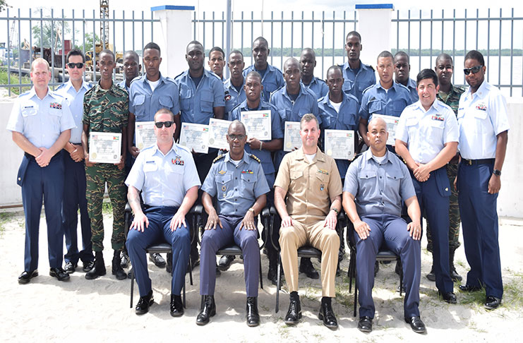 The officers and trainers of the course pose for a photograph following their graduation ceremony