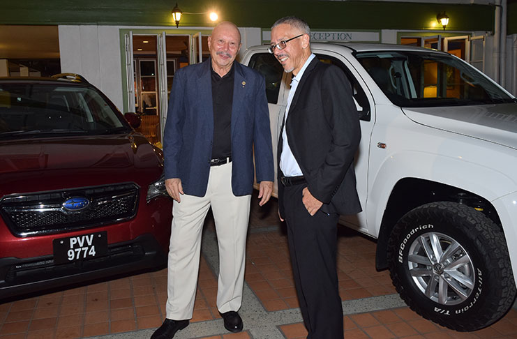 EUROPCAR Guyana Country Manager, Jan Van Charante, (left) and Minister Dominic Gaskin, in front of two of the
cars to be put into operation as EUROPCAR kicks off