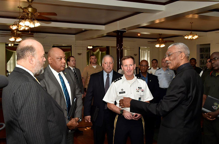 President David Granger converses with Military Deputy Commander of the United States (U.S.) Southern Command, Lieutenant- General Joseph DiSalvo , before their meeting at State House. Ambassador Perry Holloway and Minister of Natural Resources, Mr. Raphael Trotman  are left and second from left respectively. [Adrian Narine photo]