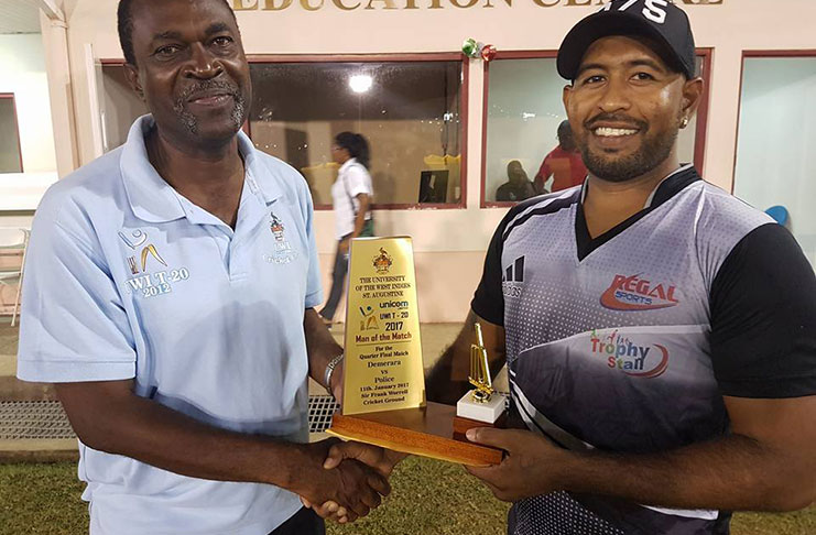 DCC's Gajanand Singh receives Man- of- the- Match award from Dr Trevor Alleyne (left), Co-ordinator of the UWI UNICOM T20 tournament being staged at the Sir Frank Worrell ground, St Augustine Campus, T&T.