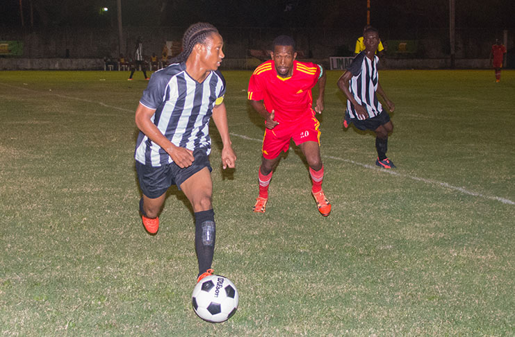 An Ann’s Grove player pays keen attention to his Santos opponent during last evening’s 2017 Limacol Round-Robin Knock-Out Football tournament at the GFC ground Bourda. (Delano Williams photo)