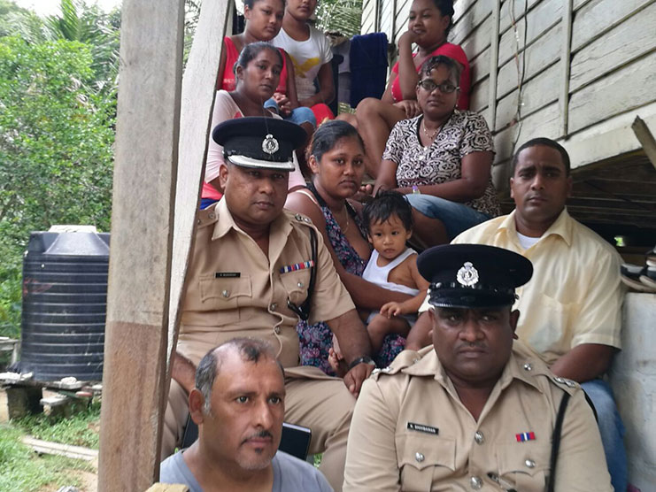 Commander of “F” Division- Senior Superintendent Ravindradat Budhram and Assistant Superintendent Kamraj Shivbarran with civil society representative and some of the relatives of the deceased police rank.