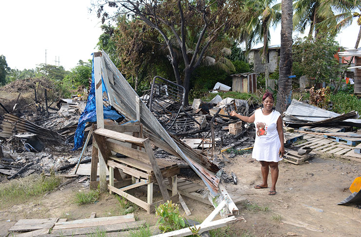 Yonette Roberts points to what remains of the house in which she and her family once lived