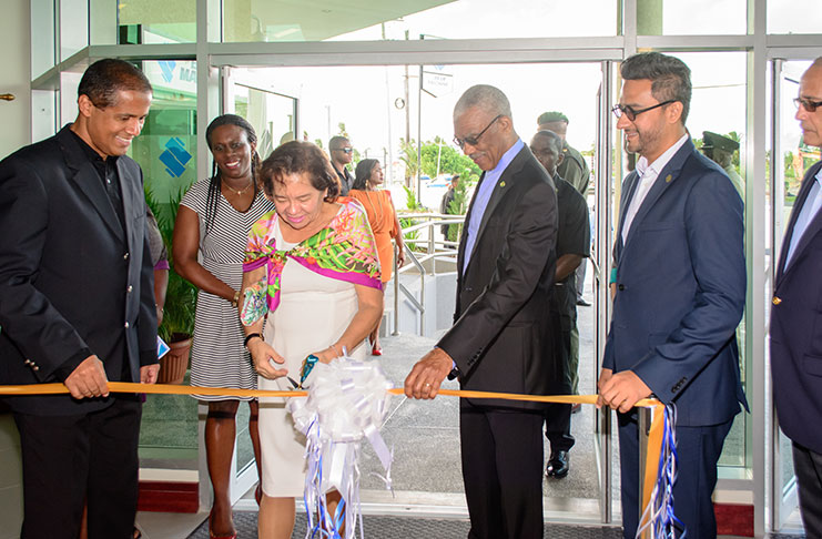 First Lady Sandra Granger cuts the ribbon to officially open Republic Bank’s Triumph, East Coast Demerara branch on Sunday. Also in photograph are President David Granger; Chairman of Republic Bank (Guyana) Limited, Nigel Baptiste (left); Managing-Director of Republic Bank (Guyana) Limited, Richard Sammy (right) and Manager, Legal Services/ Corporate Secretary Republic Bank (Guyana), Christine McGowan