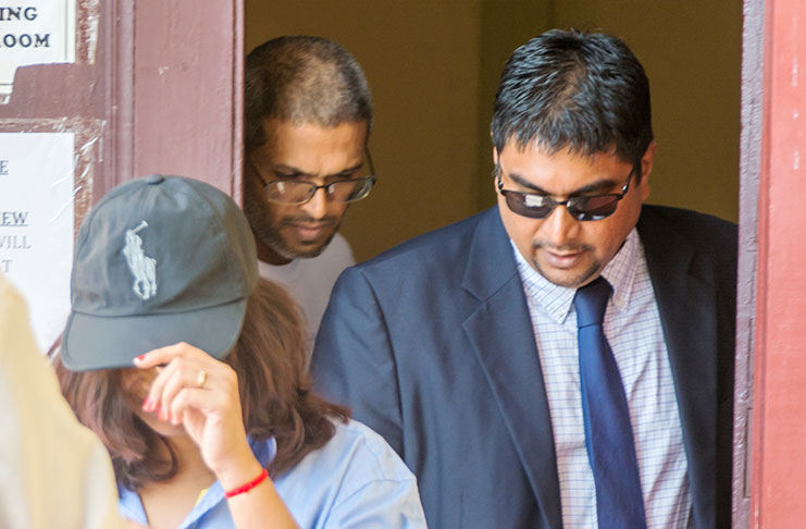 Omar Shariff, centre, his attorney, right and partner, left,exiting the courtroom recently