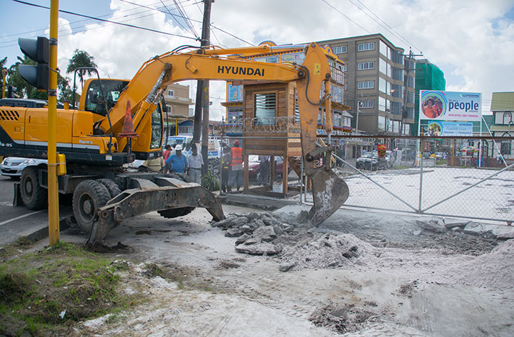 The pavement elevation in front of the entrance to the Teleperformance parking lot, being dismantled by workers of City Hall [Delano Williams photos]