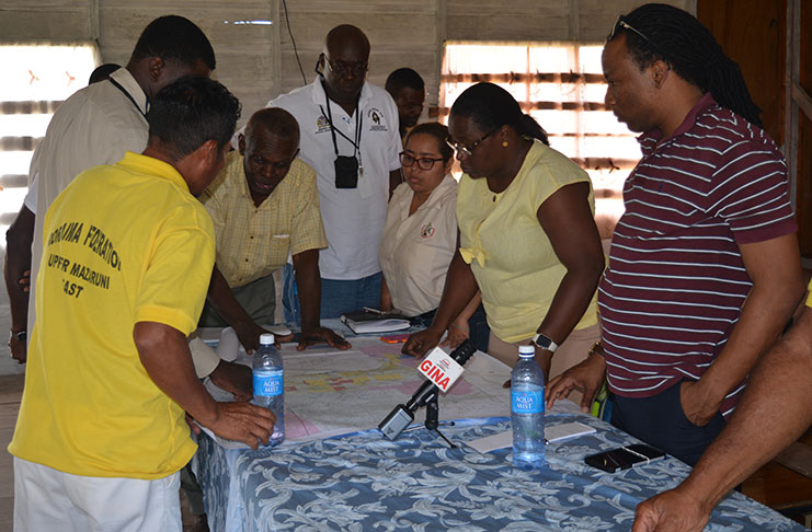 Minister within the Ministry of Natural Resources, Simona
Broomes and residents of Imbaimadai assessing possible
mining lands that the syndicate can access. Also in the photo
is MP Jermaine Figueira (extreme right)