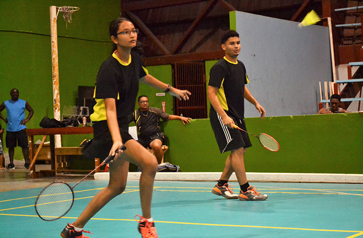 Priyanna Ramdhani (left) goes for a ground stroke during her match.