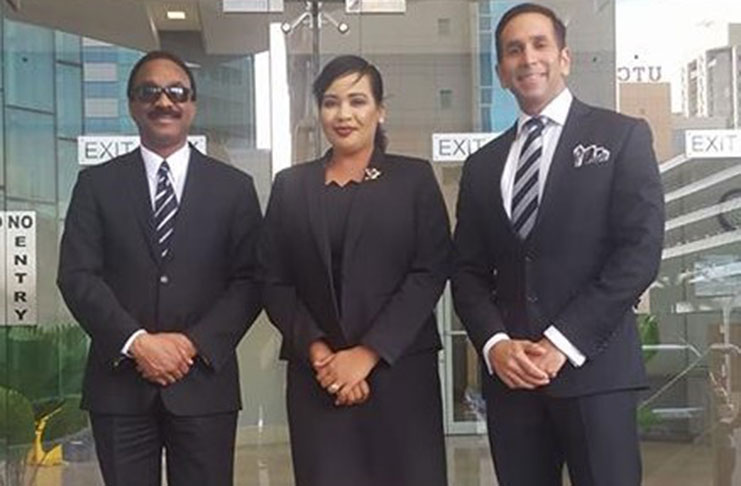 Attorney General Basil Williams and his Trinidad and Tobago counterpart, Faris AL- Rawi with Judy Stuart of the AG Chambers here pose for a photograph during a meeting in T&T