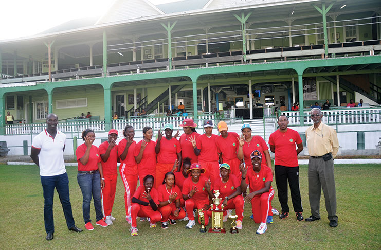 The victorious Berbice team pose with winning trophy. Coach Andre Percival is second from right, standing, along with GCB officials.